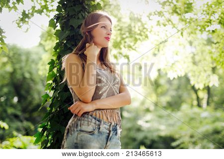 Beautiful happy woman speding time in green nature