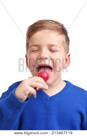 Boy enjoying licking lollipop with closed eyes close-up on white isolated background