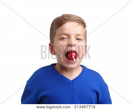 A white boy holds the whole red lollipop teeth on a white isolated background