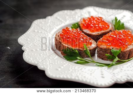 red caviar on black bread with butter. Healthy food. Fish appetizer.