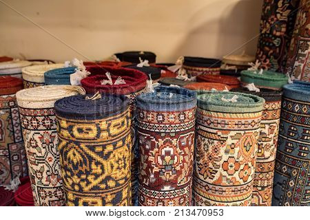 Variety of colorful Persian and Indian carpets on oriental bazaar