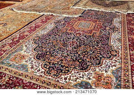 Variety of colorful Persian and Indian carpets on oriental bazaar