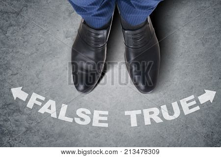 Businessman feet facing difficult choice dilemma