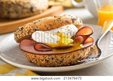A delicious breakfast bagel with poached egg and black forest ham.
