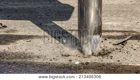 Excavator breaking and drilling the concrete road for repairing close up