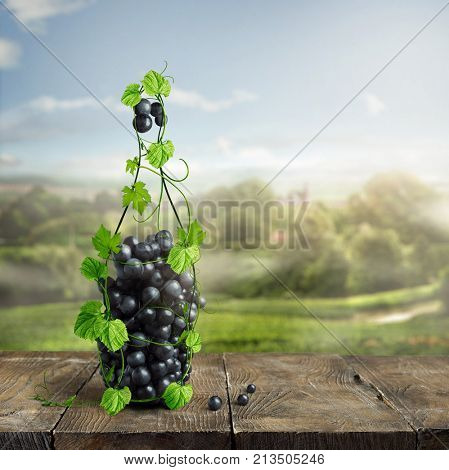 bottle of wine made from grapevine and grapes on an old wooden background