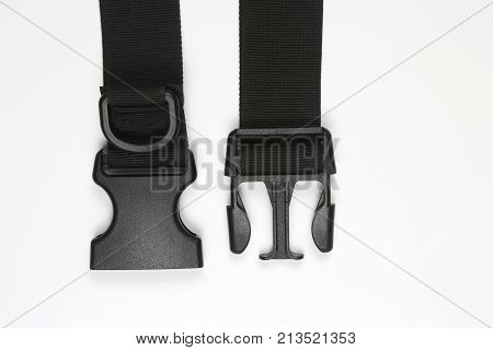 black plastic Fastex clip for backpacks on a white background