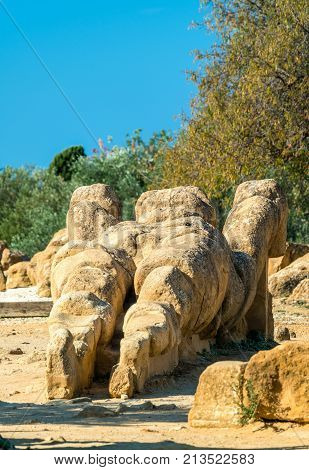 Fallen statue of Atlas at the Temple of Olympian Zeus in the Valley of Temples near Agrigento, Sicily - Italy