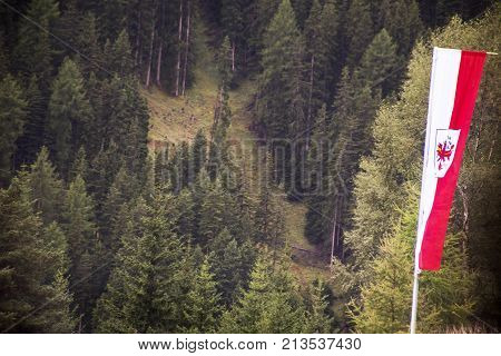 Flag tyrol state of Austria at beside road go to Samnaun is a high Alpine village and a valley at the eastern end of Graubunden region in Switzerland