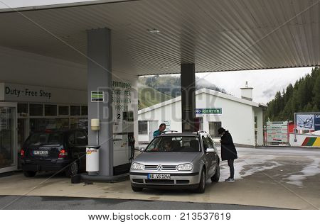 Swiss and traveler people fill oil to tank of car in petrol station at Villages of Tschlin and Ramosch near Samnaun on September 2 2017 in Graubunden Switzerland