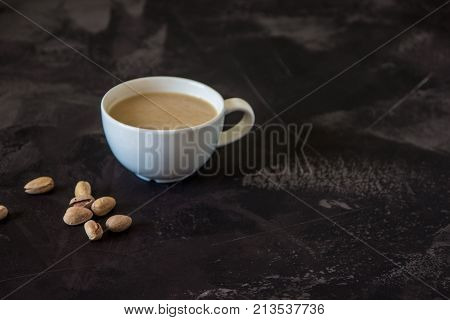 Coffee With Milk And Pistachios On The Table, Copy Space