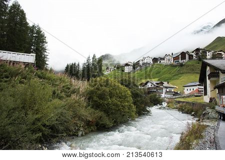 Stream And Glacier From Alps Highest And Most Extensive Mountain Range Flowing Passed At Villages Of