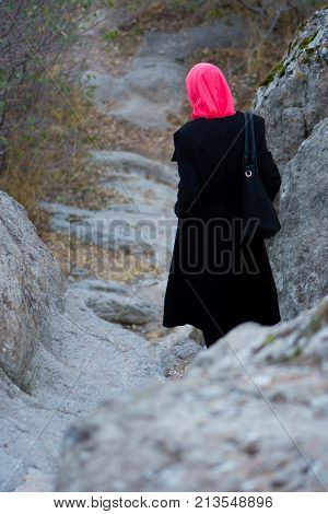 Muslim woman on a stone stairway in the castle