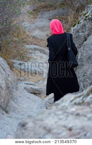 Muslim woman on a stone stairway in the castle