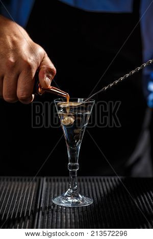 The Bartender makes Brain shot drink on bar counter