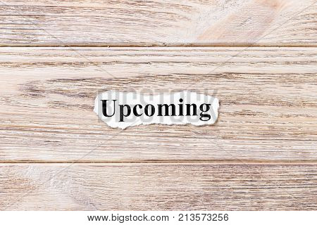 Upcoming of the word on paper. concept. Words of Upcoming on a wooden background.