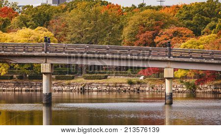 Famous tourist attraction Gokurakubashi bridge at Osaka castle garden in autumn.
