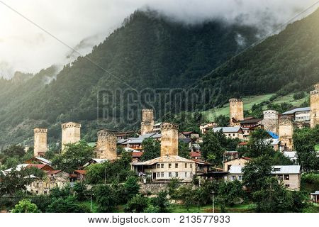 View on swan towels in Mestia, Svaneti region, Georgia. Misty fod above green forest.