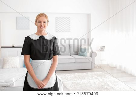 Beautiful chambermaid in room