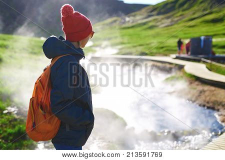 woman traveler on a walk in the Valley of the river of Hveragerdi Iceland. Hiking Tour of Reykjadalur Hot Springs