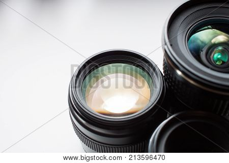 close-up view of a group of camera lenses on a white surface