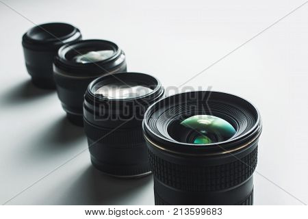 Close-up View Of A Group Of Camera Lenses On A White Surface