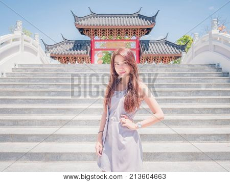 The girl wearing dressed indigo color and standing on the ladder. In one temple.
