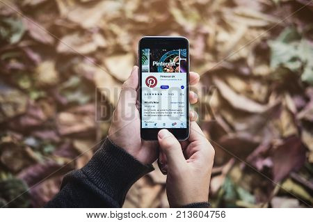 Chiang Mai Thailand Nov 102017: Man hand holding iphone 6s with social Internet service Pinterest on the screen. Pinterest is an online pinboard that allows people to pin their interesting things.