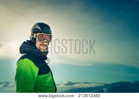 Portrait of a skier in the mountains. Free Lifestyle freedom. Winter in the mountains outdoor. Image toned.