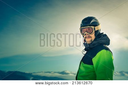 Portrait of a skier in the mountains. Free Lifestyle freedom. Winter in the mountains outdoor. Image toned.