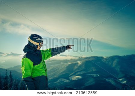 Portrait of a skier in the mountains. Free Lifestyle freedom. Winter in the mountains outdoor. Image toned.