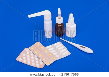 Medications, Pills And A Thermometer On A Bright Background