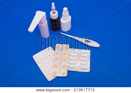 Medications, Pills And A Thermometer On A Bright Background
