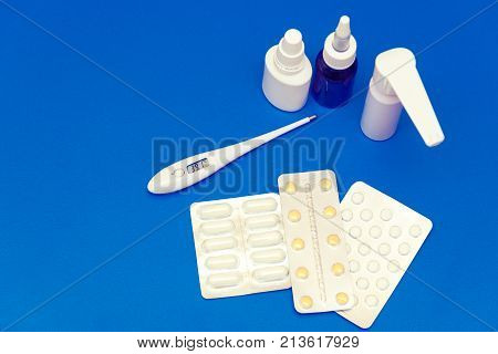 Medications, Pills And A Thermometer On A Bright Background
