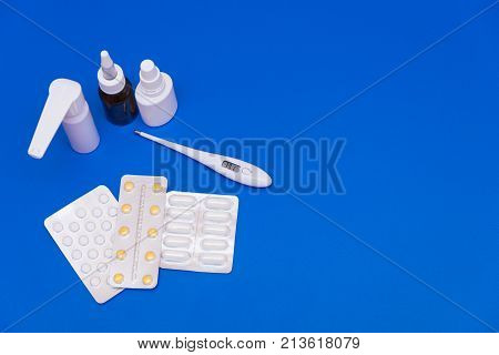 Medications, Pills And A Thermometer On A Bright Background
