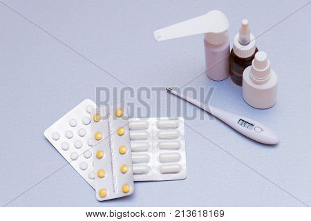 Medications And A Thermometer On A Light Background