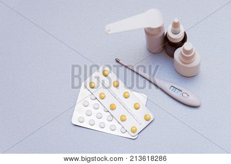 Medications And A Thermometer On A Light Background