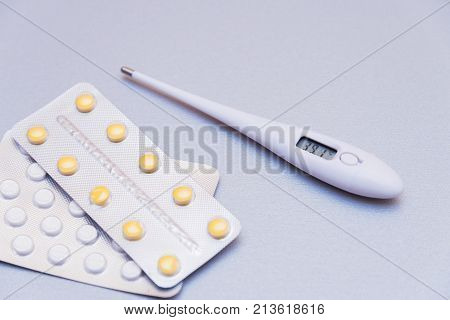 Medications And A Thermometer On A Light Background