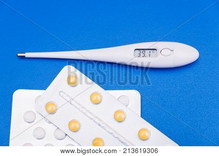 Medications, Pills And A Thermometer On A Bright Background