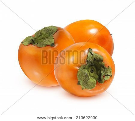 Sweet persimmon isolated on white background. Three whole ripe fruit with shadow.