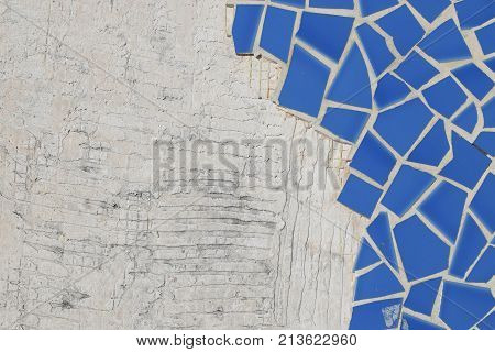 Broken ceramic floor tiles and concrete background.