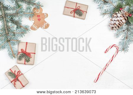 Christmas gifts fir tree branches xmas holiday decorations festive symbols on white wooden background with copyspace. Christmas composition.