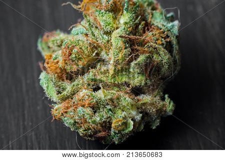Macro photos of marijuana cones with leaves covered with trichomes. The cannabis plant clse view.