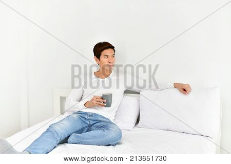 Men are playing mobile in the bedroom.