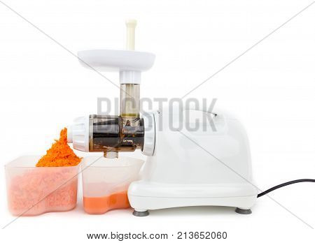 Making fresh carot juice using juicer on the white background
