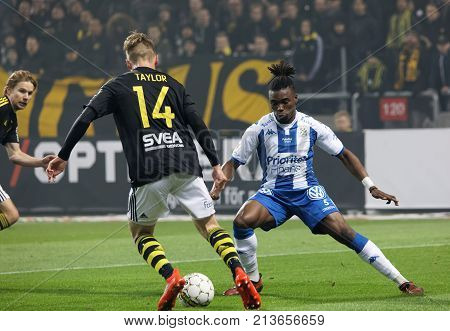 SOLNA SWEDEN - OCT 30 2017: Soccer player Robert Taylor (AIK) dribble to pass Sam Adekube (IFK Goteborg). October 30 2017SolnaSweden