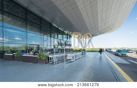 ZAGREB AIRPORT - 24 APRIL 2017: Arrivals exterior with passengers in cafe.