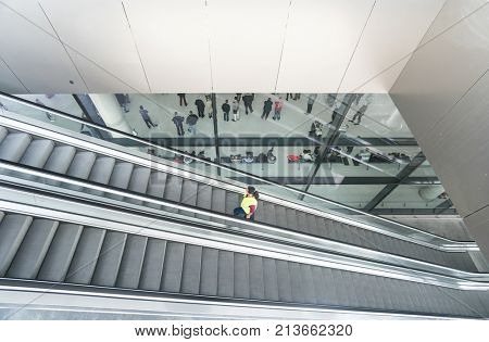 ZAGREB AIRPORT - 24 APRIL 2017: Aerial view of passengers waiting in hall, escalators passing.