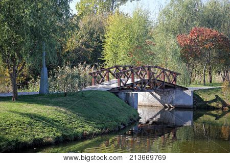 Wooden bridge in the park during fall season.