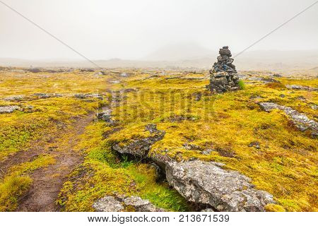 Grabrok crater path with fog in summer
